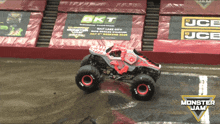 a monster jam truck is on a dirt track