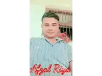 a man in a blue shirt is sitting in front of a window with the name absal riya written in red