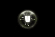 a green circle with arrows pointing to a white object