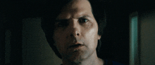 a close up of a man 's face in the dark