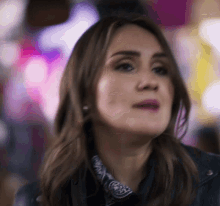 a close up of a woman wearing a bandana and a leather jacket