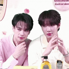 two men sitting next to each other with a bottle of pantene in the foreground