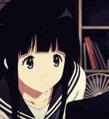 a girl with black hair and purple eyes is looking at something