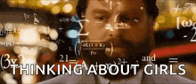 a man with a beard is standing in front of a screen that says thinking about girls