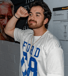 a man with a beard wears a white t-shirt with the number 59 on it
