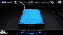 a pool table with a blue cloth and a diamond logo on it