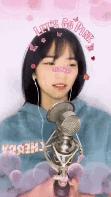 a girl singing into a microphone with the words let 's go pink on her head