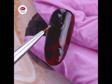 a close up of a nail being painted with a brush that says nails