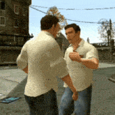 two men standing next to each other with one wearing a shirt that says ' a ' on it