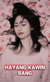 a woman in a pink shirt is laying in a pile of pink roses with hayang kawin bang written on the bottom