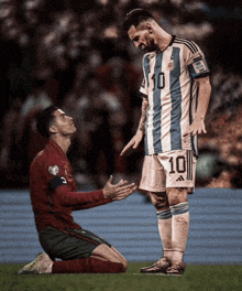 a soccer player with the number 10 on his jersey is kneeling down