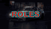 a car is driving down a wet street with the word roles written in red