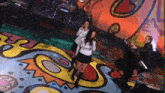 a woman singing in front of a drum set that says #tama on it