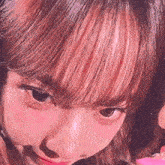 a close up of a woman 's face with pink lipstick