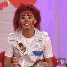a man in a clown costume has a name tag that says " freddy " on it
