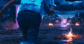 a video game scene with a cube in the middle of a field and a purple light coming out of it .