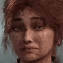 a close up of a woman 's face with a scar on her nose .