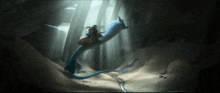 a person riding on the back of a blue dragon in a cave