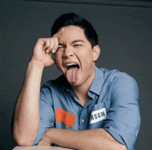 a man sticking his tongue out and wearing a shirt with msgm on it