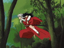 a man in a red kimono is carrying a girl on his back