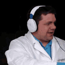 a man wearing headphones with the word pokémon on his shirt