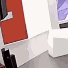 a blurred image of a room with a white wall , a red door , and a purple box .