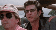 a man wearing a hat that says jurassic park