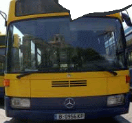 a yellow mercedes bus with license plate b-956 kp