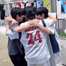 a group of young men are hugging each other in a store .