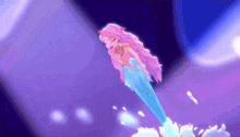 a mermaid with pink hair and a blue tail
