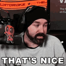 a man with a beard is wearing headphones and a beanie and says that 's nice .