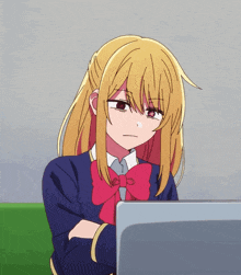 a girl with blonde hair and a red bow is sitting in front of a laptop computer