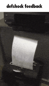 a piece of paper is coming out of a paper shredder with the words defshock feedback above it