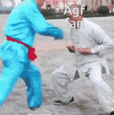 a man in a blue suit is fighting another man in a white suit .