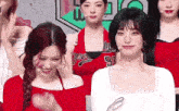 a group of young women are standing next to each other and smiling .
