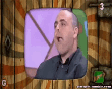 a gif of a man talking on a tv screen with the number 3 on it