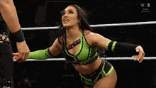 two female wrestlers are standing in a ring with the word raw on the bottom