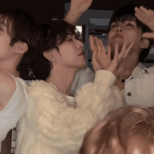 a group of people are playing with each other and one of them is wearing a white sweater