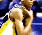 a basketball player in a yellow and black jersey with the number 5 on it