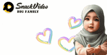 a baby wearing a hijab is standing in front of a banner that says " snack video big family "