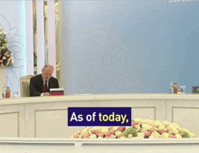 a man sits at a table with a sign that says ready-to-deploy on it