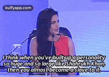a woman is sitting in front of a microphone with a quote .