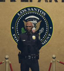 a police officer in front of a los santos police department logo