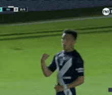 a man in a blue shirt with a white z on it