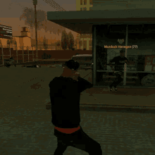 a man in a video game is standing in front of a building with murdock hanegan ( 77 ) written on it