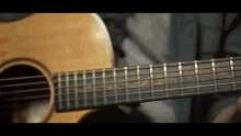 a close up of the neck of an acoustic guitar with the letters ss on it