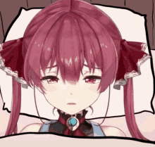 a girl with red hair is laying on a bed