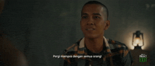 a man in a plaid shirt is talking to another man with project exit written on the bottom of the screen