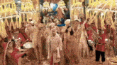 a bride and groom are dancing in front of a band playing drums