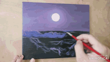 a person is painting a painting of a full moon